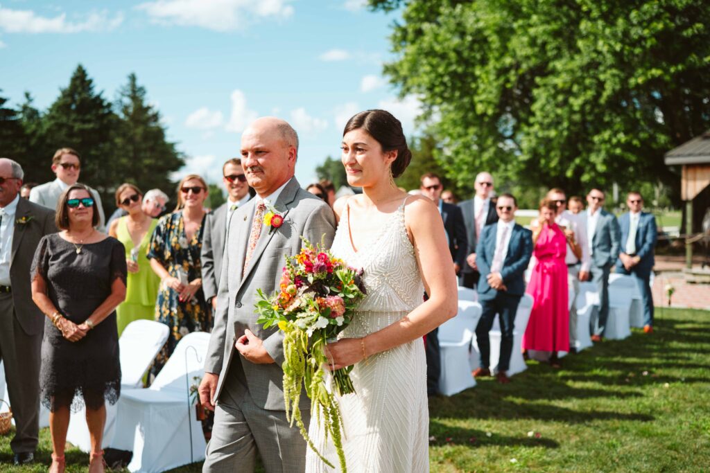 NH New England Rockingham Country Club wedding summer seacoast photographer  New Hampshire orange  wild flowers bride walking down the aisle with father