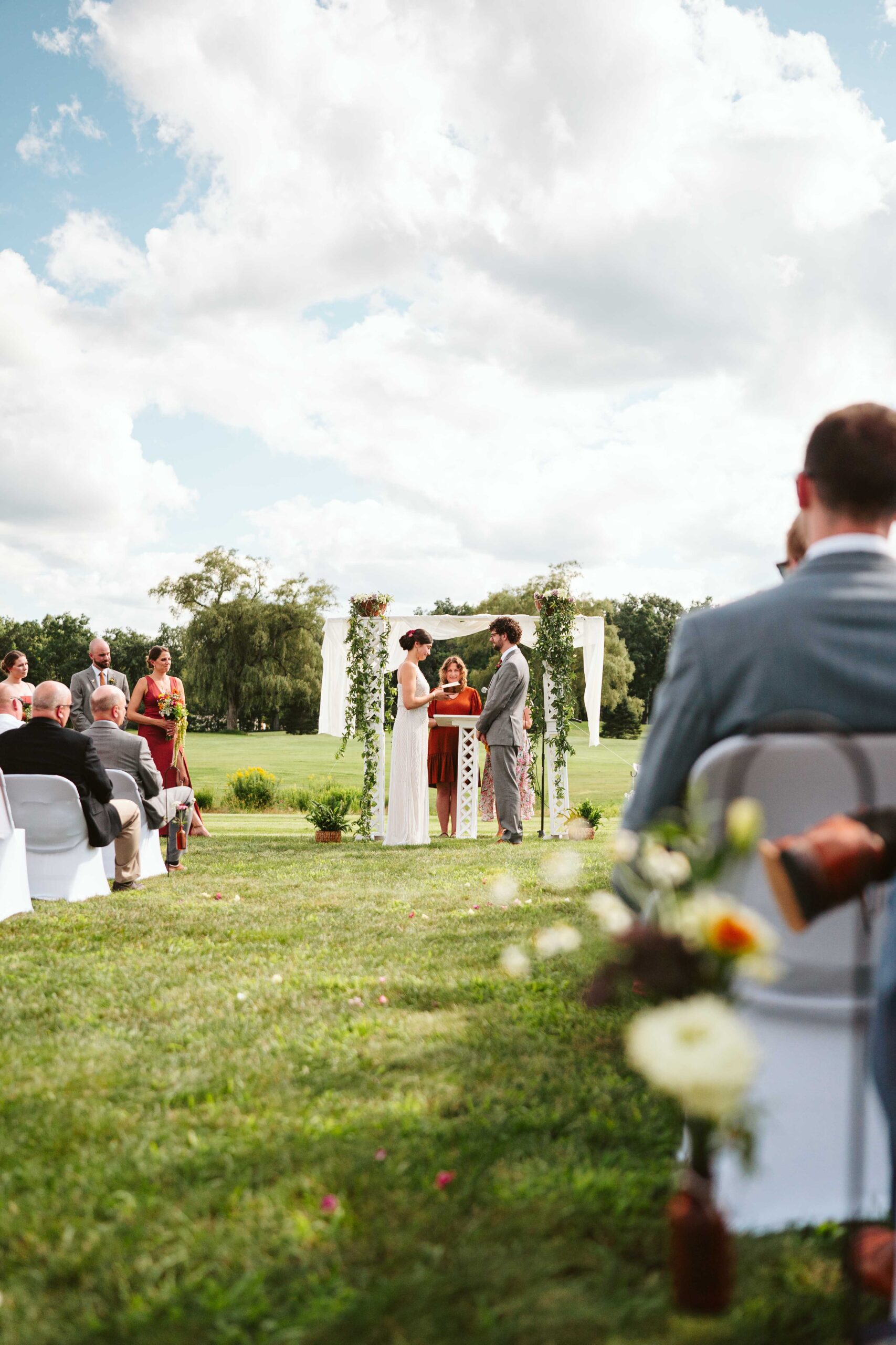 NH New England Rockingham Country Club wedding summer seacoast photographer  New Hampshire wild flowers artistic aesthetic ceremony details bottles with hanging flowers