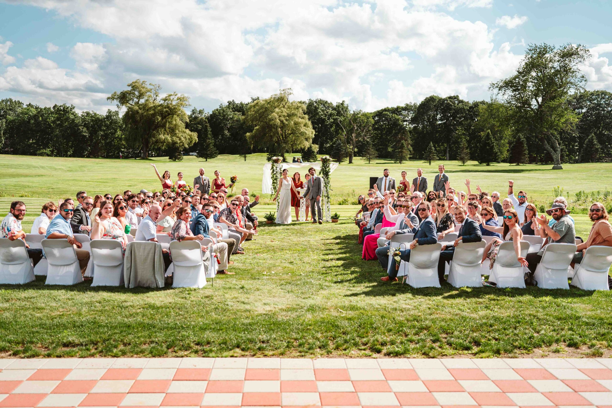 NH New England Rockingham Country Club wedding summer seacoast photographer  New Hampshire  ceremony fun group photo all the guests friends and family wave field golf course