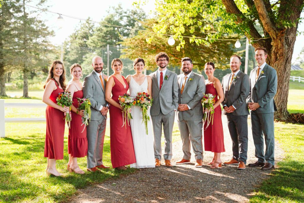 NH New England Rockingham Country Club wedding summer seacoast photographer  New Hampshire  group photo bridal party groomsmen grooms women bridesmaids brides gentlemen stringed light lanterns backlit fun