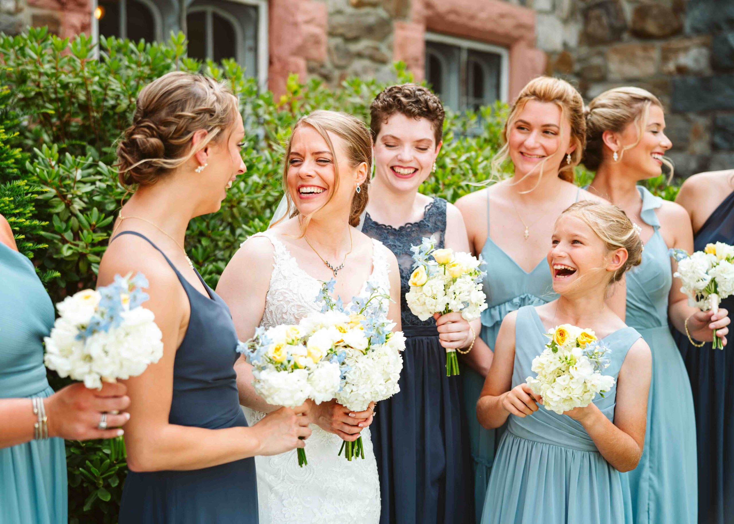 This photo shows the bride and her bridesmaids in candid moment in from of Searles Castle.