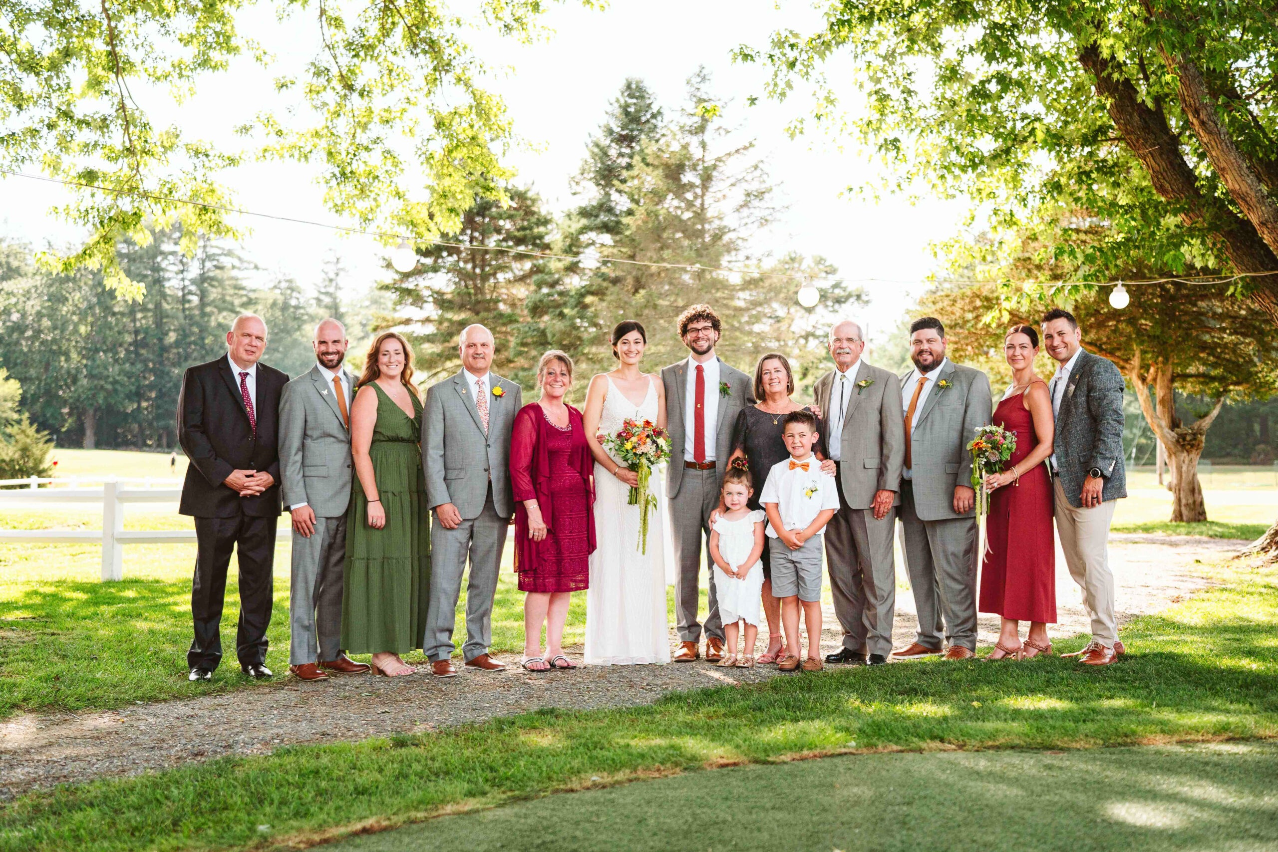 NH New England Rockingham Country Club wedding summer seacoast photographer  New Hampshire  group photo large family generational stringed light lanterns backlit fun